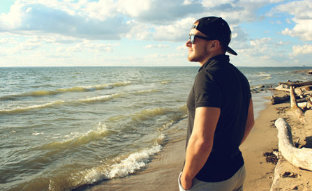 Man looking at the sea, smiling.